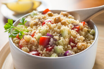 cold tabouleh of couscous in bowl and spoon