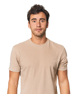 Young Hispanic man in studio sad, serious face, feeling miserable and displeased.