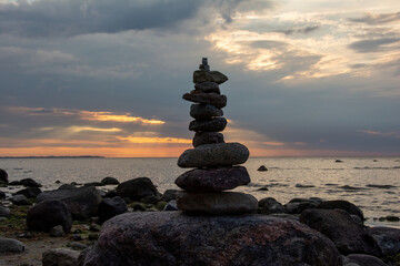 Stacked stones on a coast at sunset