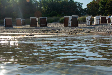 Water with a view of beach chairs in the background