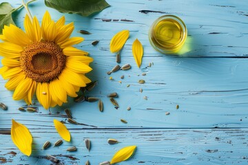Fototapeta premium Sunflower seeds and oil on blue table