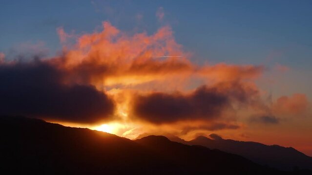 Sunset clouds in Los Machucos at 921 meters above sea level and communicates the villages of Bustablado and San Roque de Riomiera. Pasiegos Valleys, Cantabria, Spain, Europe