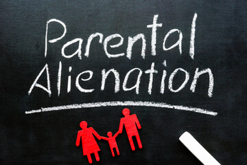 Parental alienation. Chalk inscription on a blackboard and family figures.