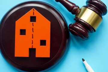 Divided line house and gavel. Division of property during divorce and inheritance.