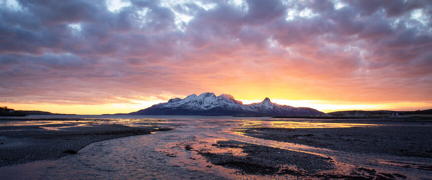 Arctic sunset in late winter / early sping with mountains still covered in snow.