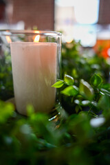 Tabletop candle in greenery