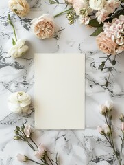 Blank paper on marble table with flowers.