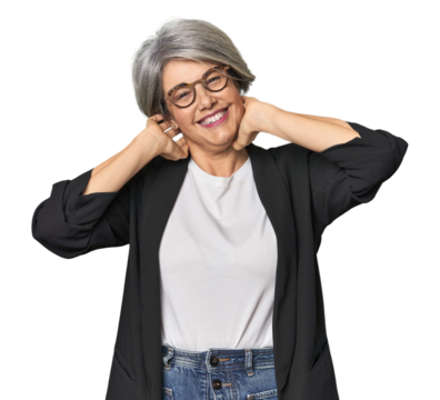 Caucasian mid-age female in business suit stretching arms, relaxed position.