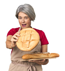 Middle-aged Caucasian female baker with bread tray