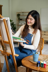 The creative person stood in his studio, lost in concentration as he worked on his latest painting.