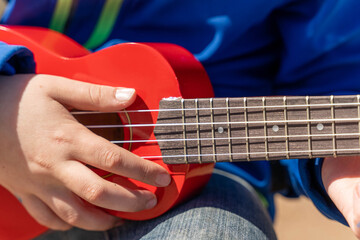 Close-up of a person playing a guitar