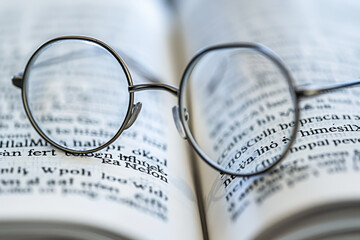 A pair of glasses is sitting on top of a book