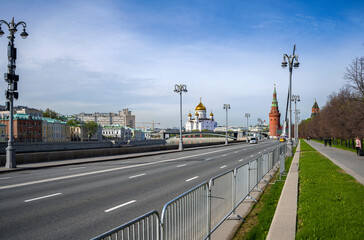Kremlin embankment in Moscow with a view of the Cathedral of Christ the Savior on a sunny morning.