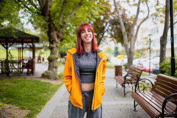 Happy Turkish young woman laughing and looking camera in park