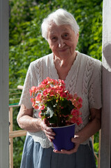 old woman with flowers on the balcony