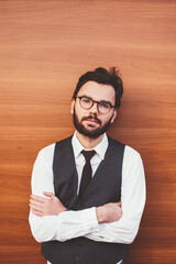 Caucasian hipster guy in formal apparel posing near copy space area for advertising text outdoors, confident man in eyeglasses standing near promotional background and looking at camera on leisure