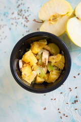 fruit salad on a light blue background top view. diet food