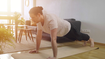 Workout at home concept. Young male doing push-up