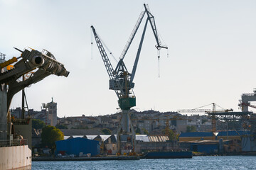 Port of Pula, Croatia, with cranes and ships. Commercial nautical dock