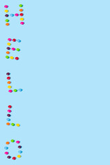 Creative idea made of candies on a blue background. Candy summer concept with copy space.