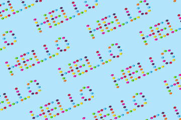 Creative idea made of candies on a blue background. Summer concept. Colorful pattern.