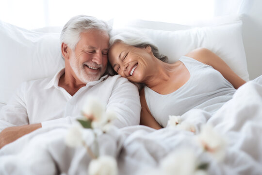 Comfortable senior couple, sleeping in bedroom and morning cuddle for rest, relax and content retirement at home. Happy, love and elderly people dreaming in marriage relationship with care lifestyle - Powered by Adobe