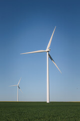 windmills of wind energy in the middle of the countryside with beautiful colors and clear blue sky, renewable energy