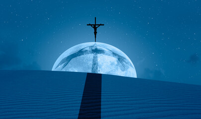 Jesus Christ on the cross over desert with full moon 
