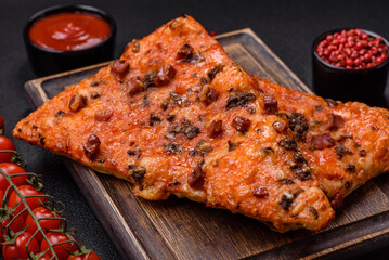 Slices of delicious street pizza with sausage, mushrooms, tomatoes and cheese