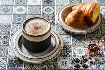 cappuccino with croissant on the table
