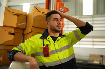 Warehouse worker working in warehouse storage. Foreman or worker work at factory site check up...