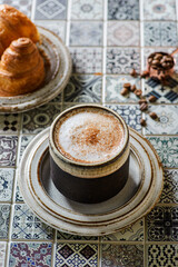 cappuccino with croissant on the table