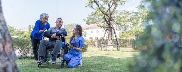 Doctor or Caregiver nurse take care a Senior patient sit on wheelchair. Doctor or Nurse helping...