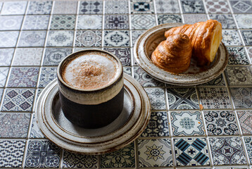 cappuccino with croissant on the table