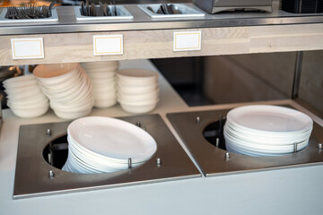 Stacked tableware. Breakfast buffet in the hotel or hostel during a self service, food concept