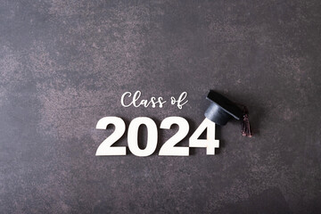 Wooden number 2024 with graduated cap. Class of 2024 concept.