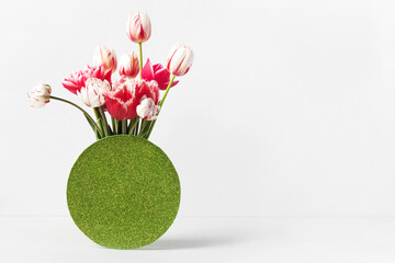 Pink and white tulips in a vase on a table with a place for text. Happy Mother's Day greeting card,...
