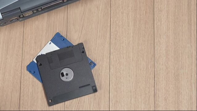Throwing vintage 3.5 floppy discs into a pile. Obsolete computer technology.