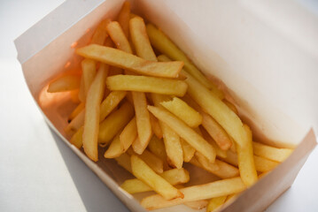 French fries in a cardboard box on a white background.