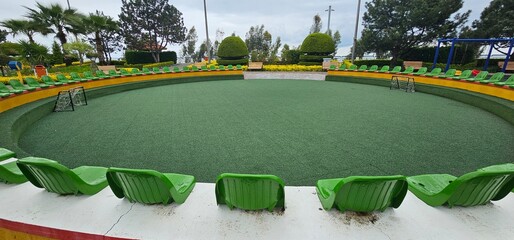 Inviting Green Lawn with Modern Chairs in a Public Park