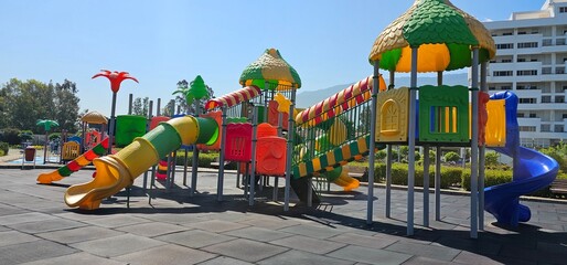 Vibrant Playground with Slide, Climbing Structure, and Carousel