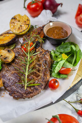 Grilled steak with vegetables and mushroom on white background