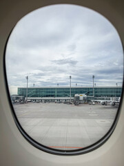 Apron and airport building at Munich Airport MUC, Germany seen through the window of an airplane