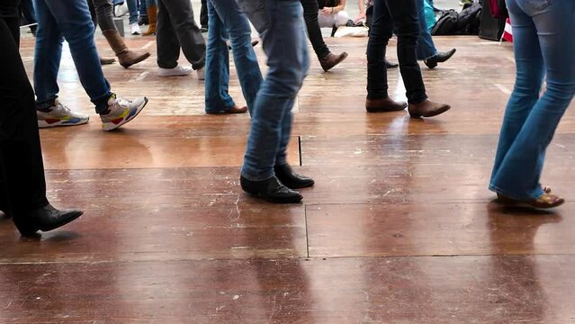 People dance with cowboy boots to typical American culture such as the Texan one. Group dances in company for fun. Quadrille conceptual Legs close up of tradition western folk 