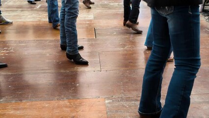 People dance with cowboy boots to typical American culture such as the Texan one. Group dances in company for fun. Quadrille conceptual Legs close up of tradition western folk 