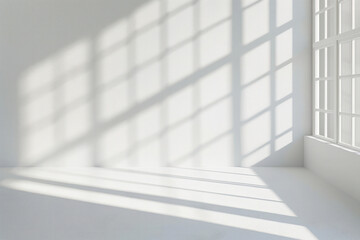 Fototapeta premium A white room featuring a window and a white wall with shadows
