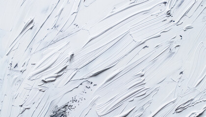 A white wall covered with numerous layers of white paint strokes, creating a textured surface