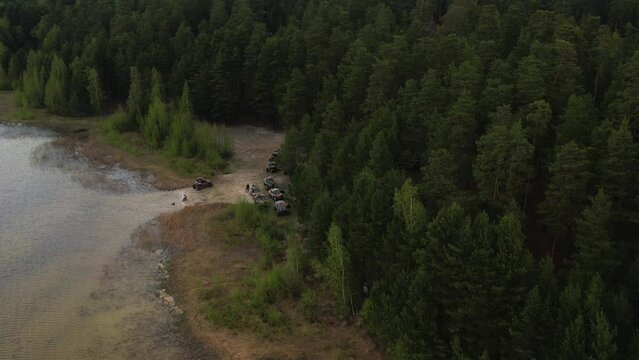 Bird's eye view of the lake in the forest. It's cloudy outside. Hiking trip