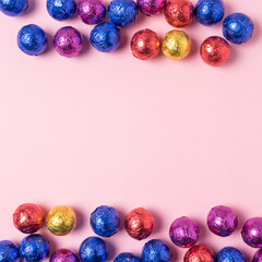 Creative layout of colored candy on pink background. Minimal hol