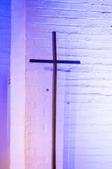 Steel cross in church in neon light